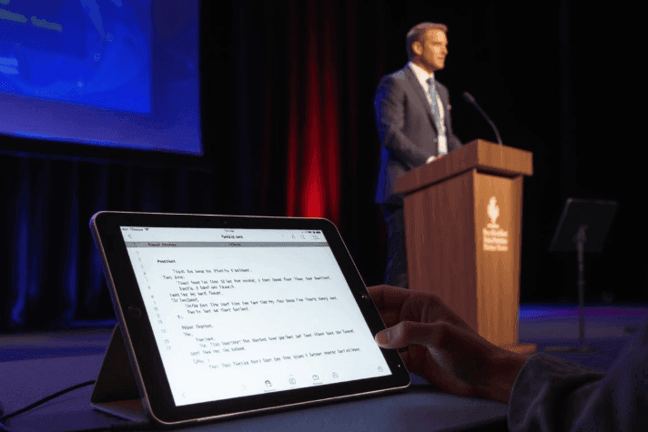 A speaker using our app for teleprompter for public speaking at a conference.